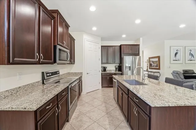 a kitchen with granite countertop stainless steel appliances and wooden cabinets