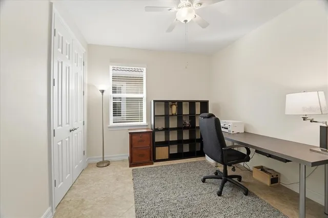 a view of a workspace with furniture and a window