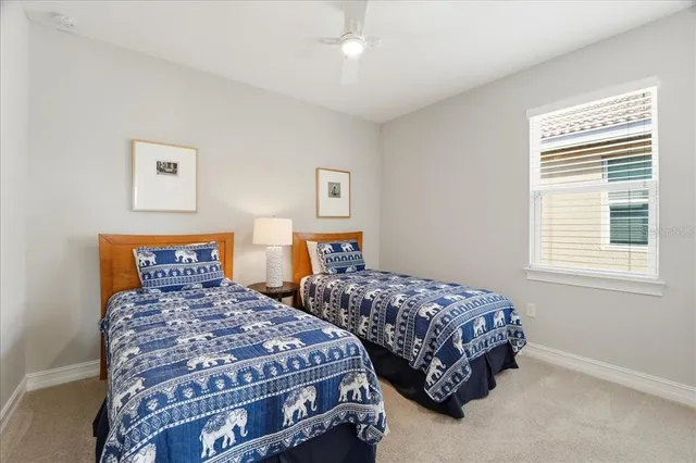 a bedroom with two beds and a dresser