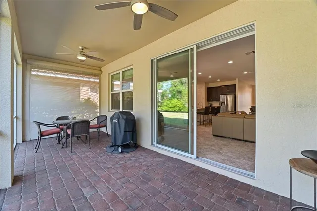 a view of a porch with furniture and a yard