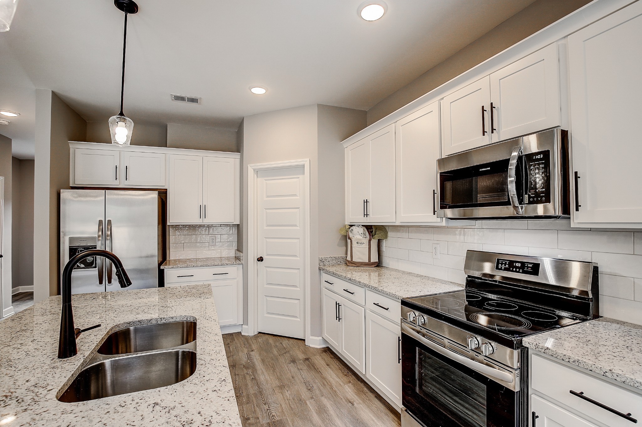 1766 Fenway Loop Antioch, TN 37013 - Photo 13 of 39 a kitchen with stainless steel appliances granite countertop a sink a stove and a refrigerator