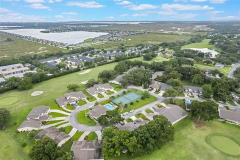 an aerial view of residential houses with outdoor space and river