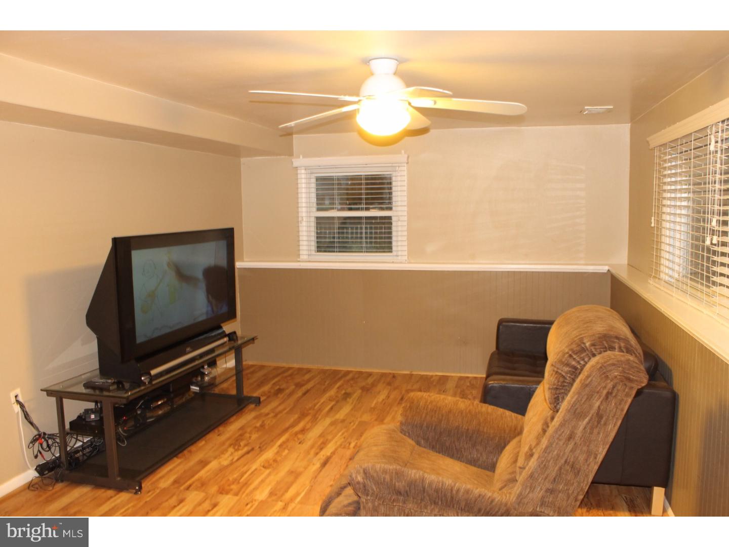 44 Hillside Road Stratford, NJ 08084 - Photo 3 of 25 a living room with furniture and a flat screen tv