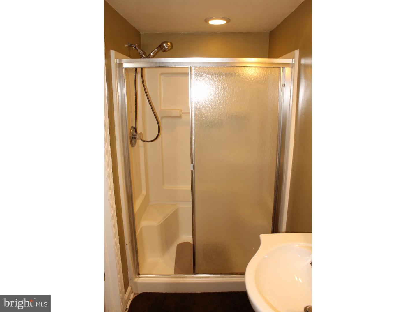 44 Hillside Road Stratford, NJ 08084 - Photo 23 of 25 a bathroom with a shower and a toilet
