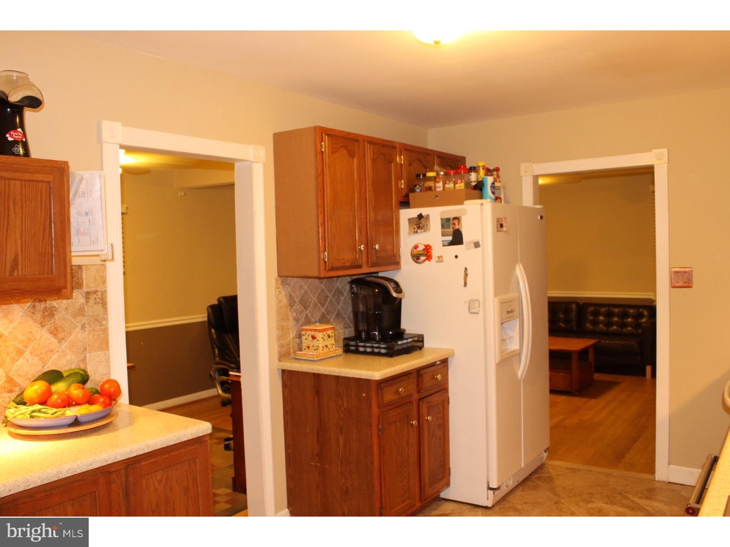 44 Hillside Road Stratford, NJ 08084 - Photo 10 of 25 a kitchen with stainless steel appliances kitchen island granite countertop a refrigerator and a sink