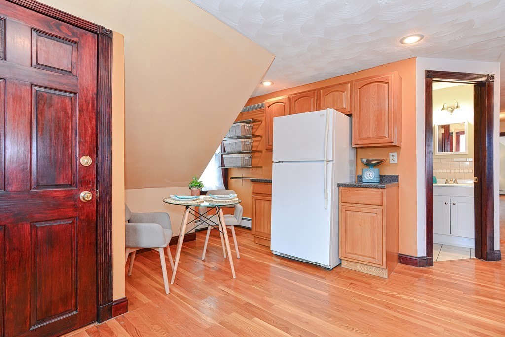 64 Hyde Park Avenue, Unit 3 Boston, MA 02130 - Photo 11 of 27 a view of kitchen with furniture and wooden floor