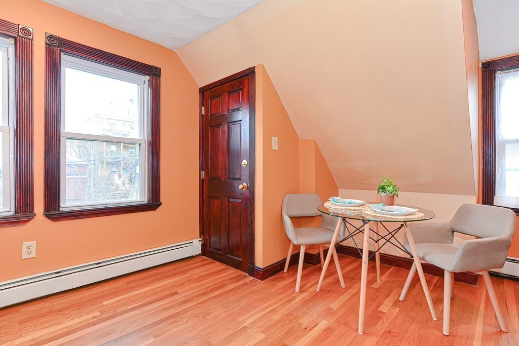 64 Hyde Park Avenue, Unit 3 Boston, MA 02130 - Photo 12 of 27 a view of a dining room with furniture and wooden floor