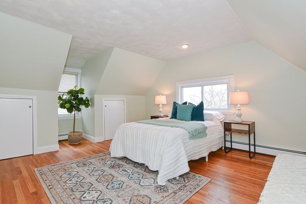 64 Hyde Park Avenue, Unit 3 Boston, MA 02130 - Photo 14 of 27 a bedroom with a large bed and a rug