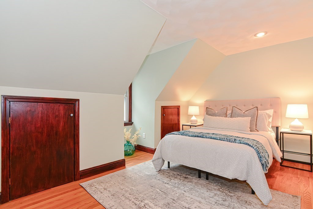 64 Hyde Park Avenue, Unit 3 Boston, MA 02130 - Photo 17 of 27 a bedroom with a bed and wooden floor