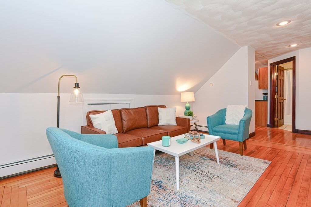 64 Hyde Park Avenue, Unit 3 Boston, MA 02130 - Photo 2 of 27 a living room with furniture and wooden floor