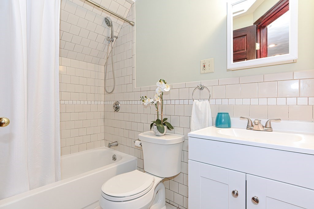 64 Hyde Park Avenue, Unit 3 Boston, MA 02130 - Photo 21 of 27 a bathroom with a sink a toilet and shower