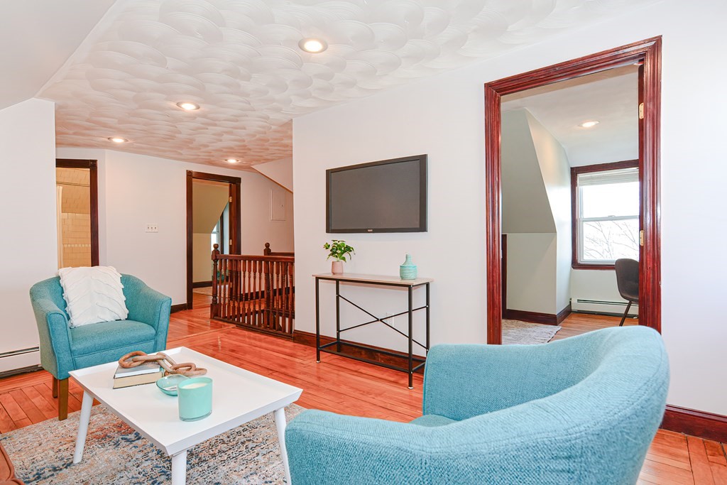 64 Hyde Park Avenue, Unit 3 Boston, MA 02130 - Photo 4 of 27 a living room with furniture and a flat screen tv