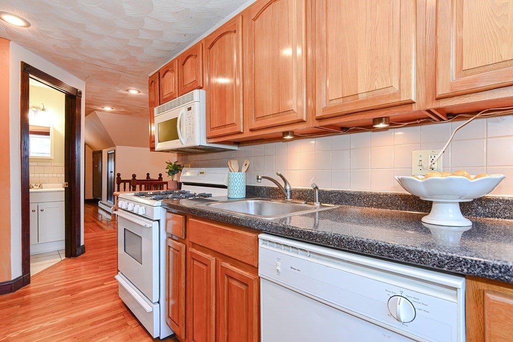 64 Hyde Park Avenue, Unit 3 Boston, MA 02130 - Photo 7 of 27 a kitchen with stainless steel appliances granite countertop a sink stove and cabinets