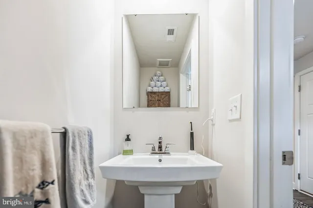 a bathroom with a sink a mirror and a toilet