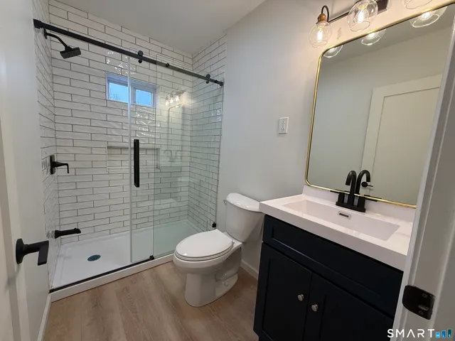 a bathroom with a sink toilet and shower