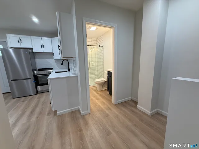 a kitchen with stainless steel appliances a refrigerator and a stove top oven