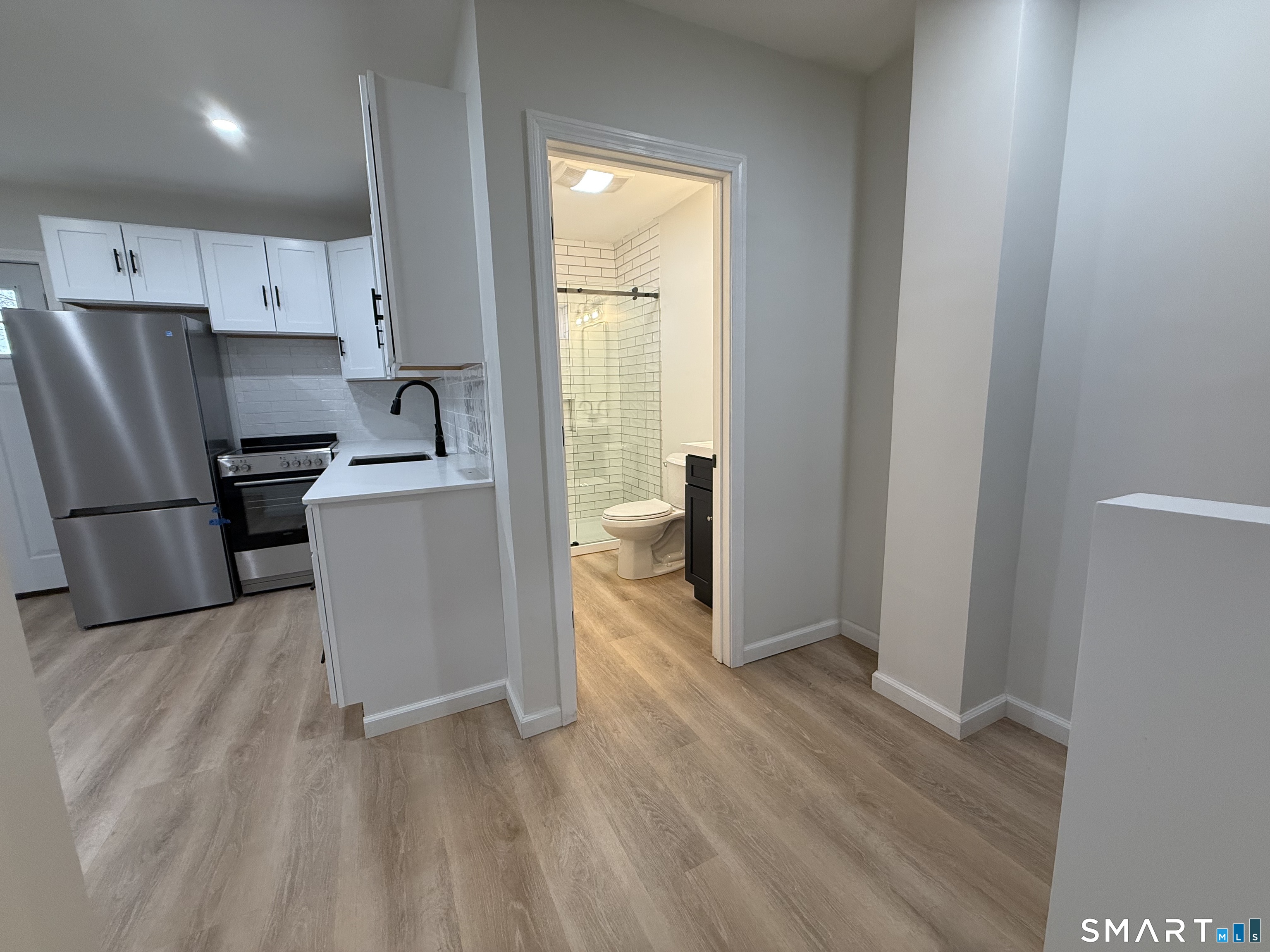 222 Pequonnock Street, Unit 2 Bridgeport, CT 06604 - Photo 3 of 10 a kitchen with stainless steel appliances a refrigerator and a stove top oven