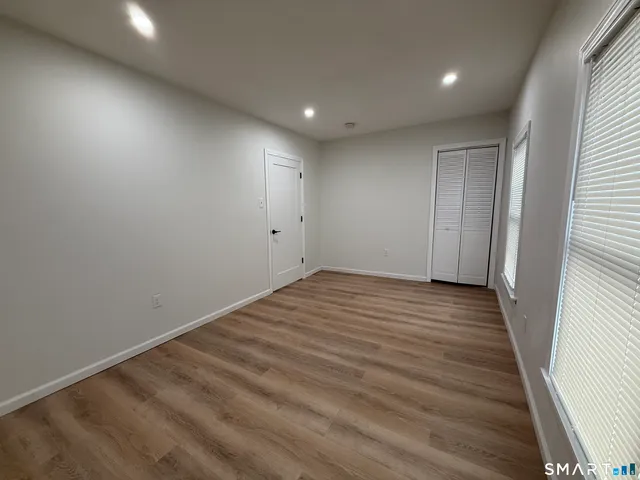 an empty room with wooden floor