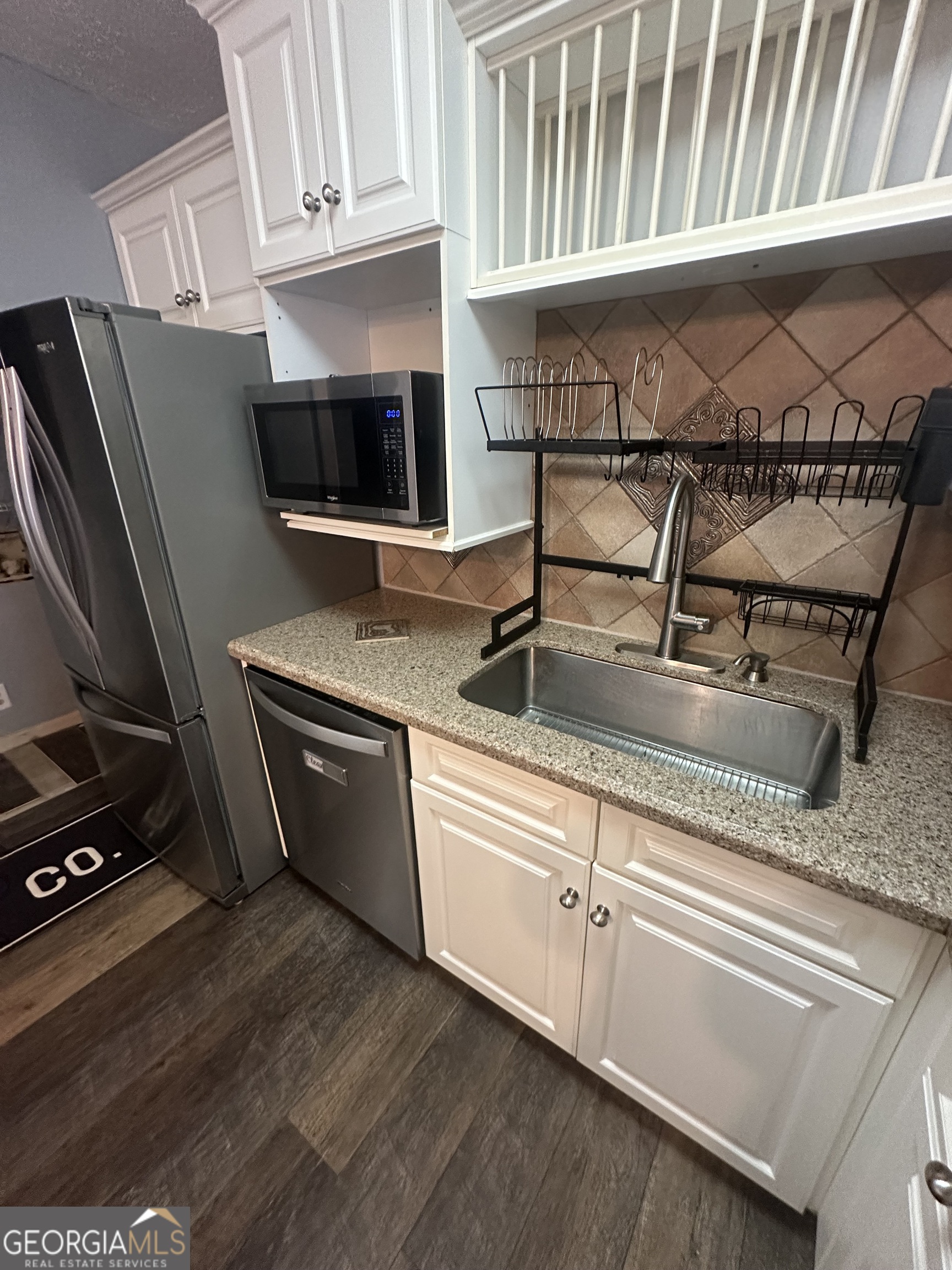 7500 Bevis Road Franklin, GA 30217 - Photo 12 of 31 a kitchen with stainless steel appliances granite countertop a sink stove and cabinets