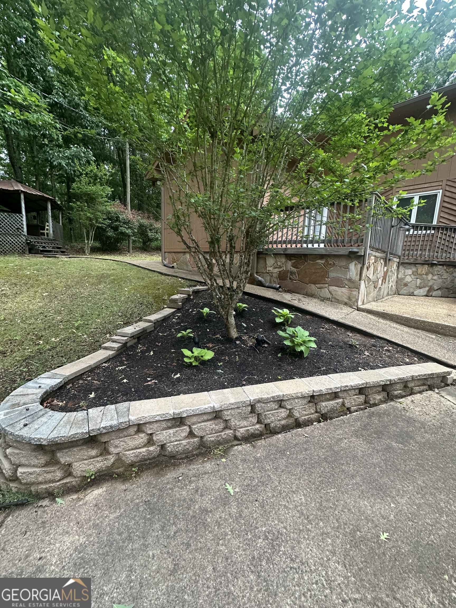 7500 Bevis Road Franklin, GA 30217 - Photo 3 of 31 a front view of a house with a garden