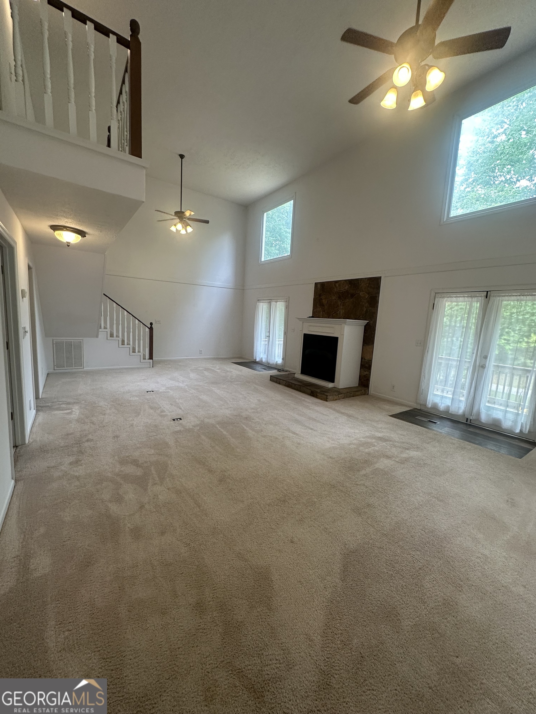 7500 Bevis Road Franklin, GA 30217 - Photo 6 of 31 a view of a livingroom with furniture and chandelier fan