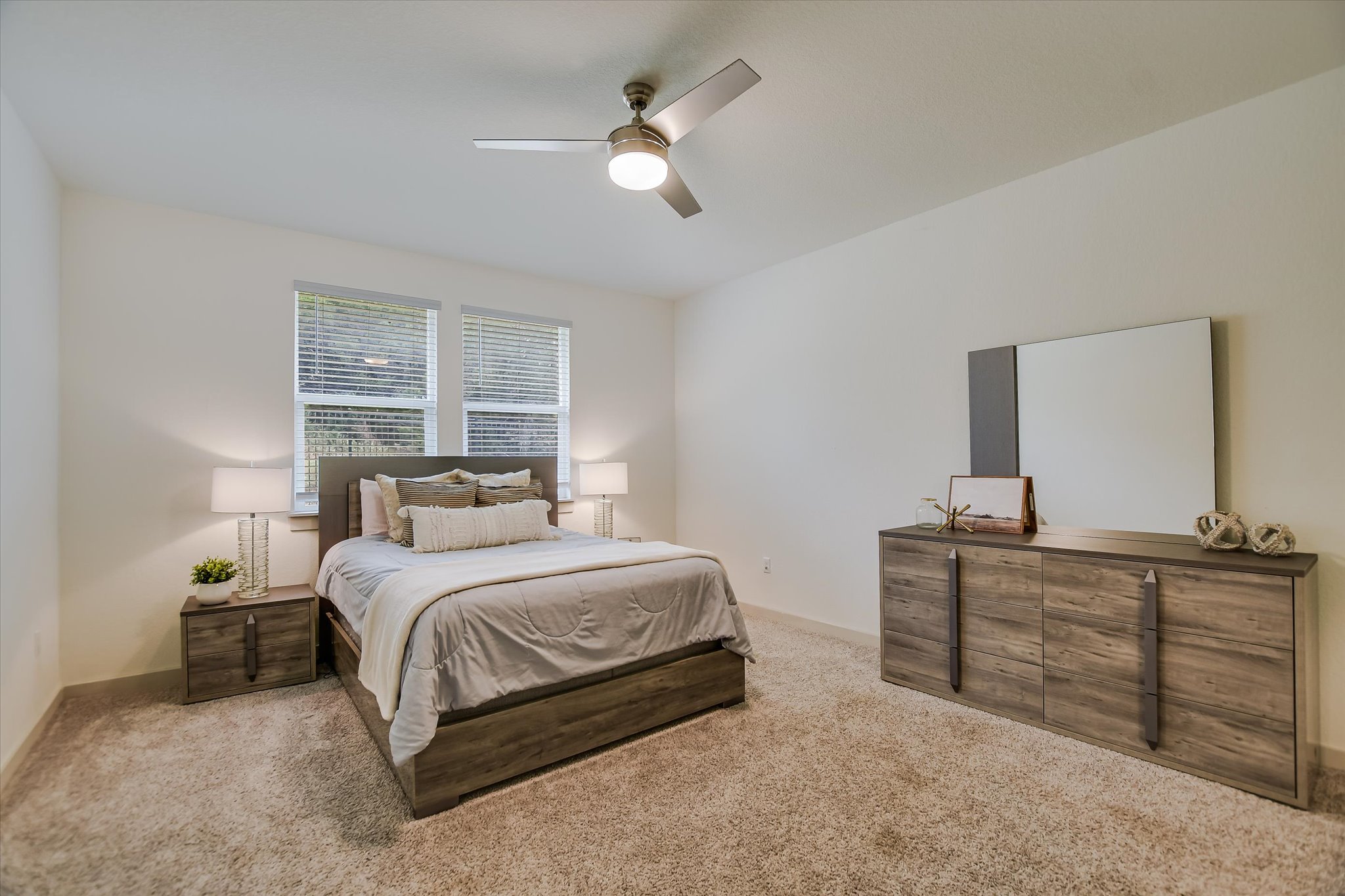 105 Merrick Road Georgetown, TX 78628 - Photo 9 of 23 A well-lit bedroom featuring a comfortable bed and complementary furniture, providing a peaceful retreat.