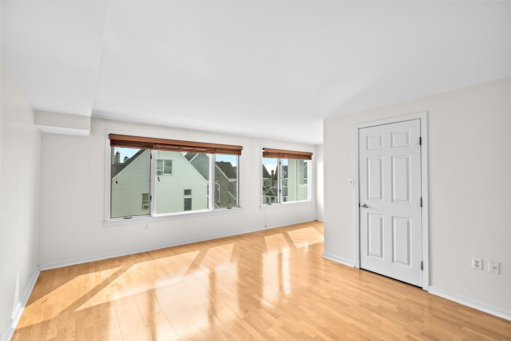 1 Commodore Court, Unit 305 Hull, MA 02045 - Photo 17 of 27 wooden floor in an empty room with a window