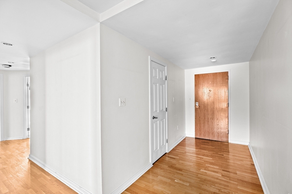 1 Commodore Court, Unit 305 Hull, MA 02045 - Photo 20 of 27 a view of a hallway with wooden floor