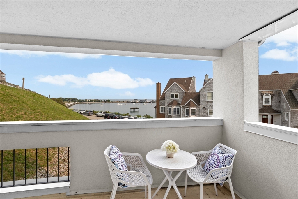 1 Commodore Court, Unit 305 Hull, MA 02045 - Photo 6 of 27 a view of a dining room with furniture window and wooden floor