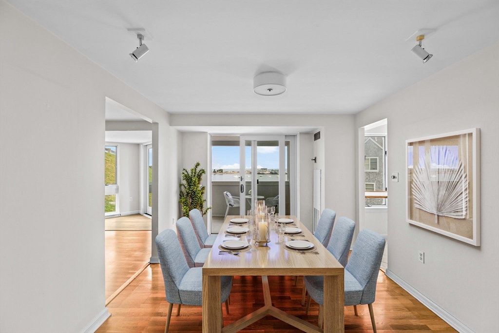 1 Commodore Court, Unit 305 Hull, MA 02045 - Photo 9 of 27 a view of a dining room with furniture window and wooden floor