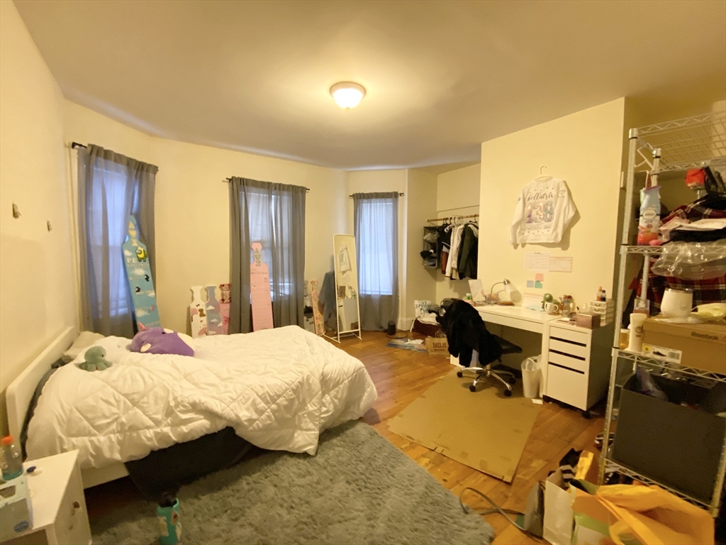 72 Calumet Street, Unit 1 Boston, MA 02120 - Photo 5 of 8 a bedroom with a bed and wooden floor