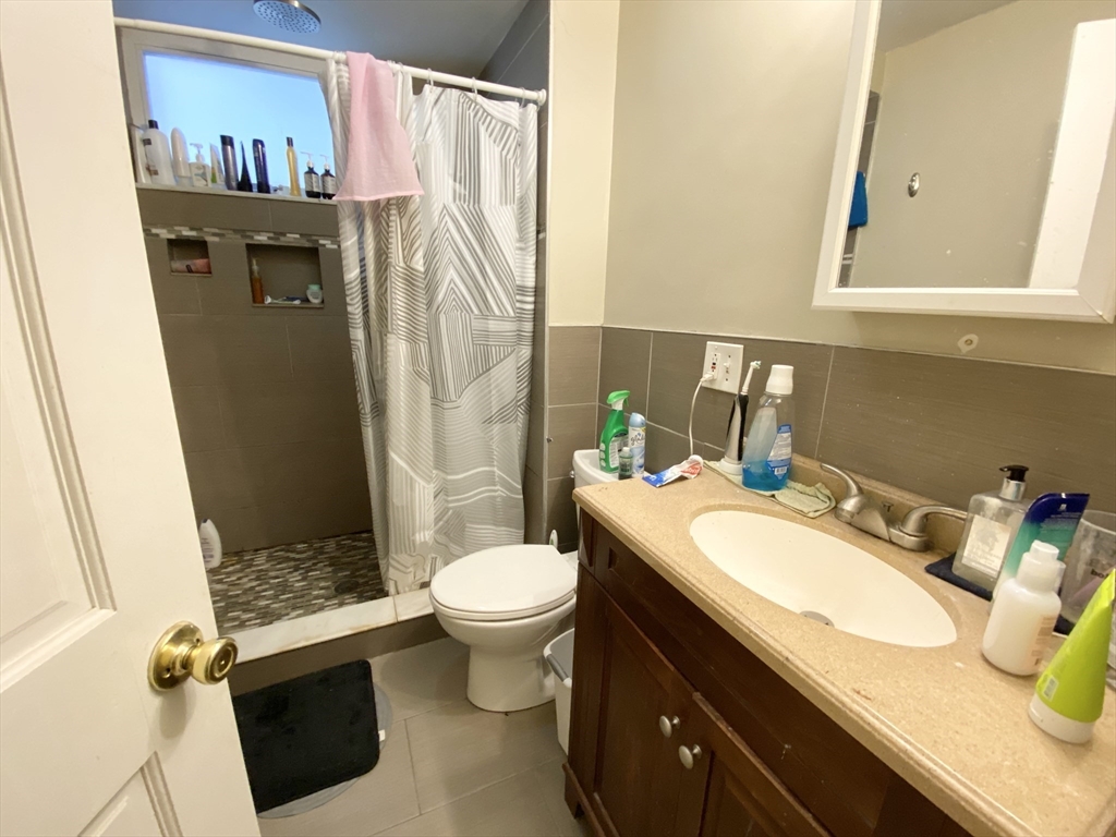 72 Calumet Street, Unit 1 Boston, MA 02120 - Photo 8 of 8 a bathroom with a sink a toilet and shower