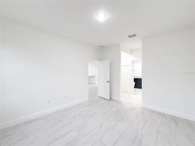 a view of a room with wooden floor and white walls