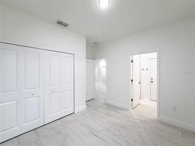 a bathroom with a granite countertop sink toilet and mirror