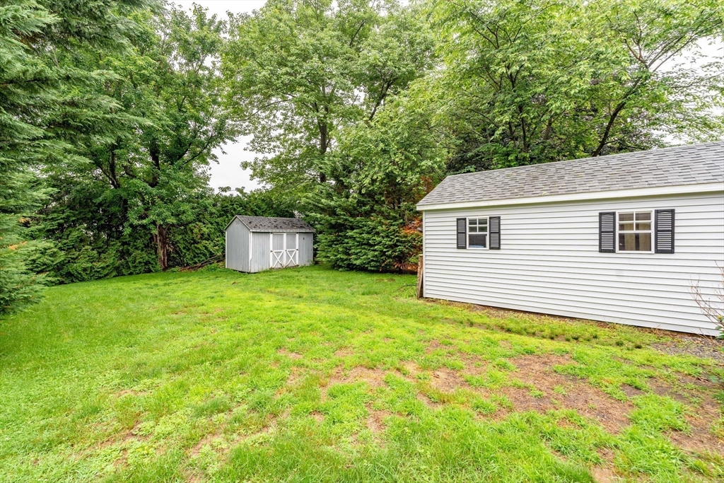 267 Maple Street East Longmeadow, MA 01028 - Photo 23 of 25 a backyard of a house with plants and large tree