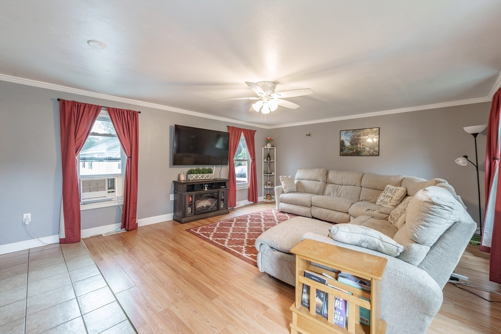 267 Maple Street East Longmeadow, MA 01028 - Photo 4 of 25 a living room with furniture a flat screen tv and a fireplace