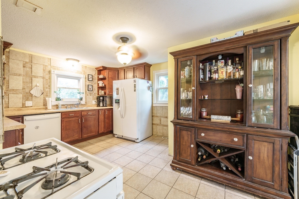 267 Maple Street East Longmeadow, MA 01028 - Photo 8 of 25 a kitchen with a stove a refrigerator and a dining table