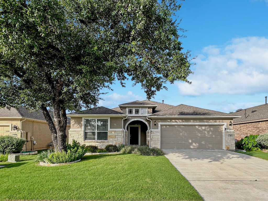 a front view of a house with a yard and garage