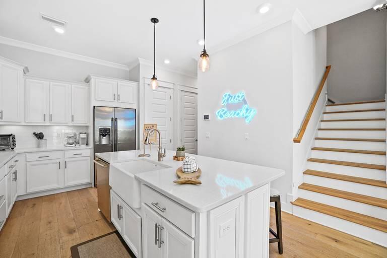 296 Milestone Dr Inlet Beach, Unit B Inlet Beach, FL 32461 - Photo 4 of 4 a kitchen with white cabinets and white appliances