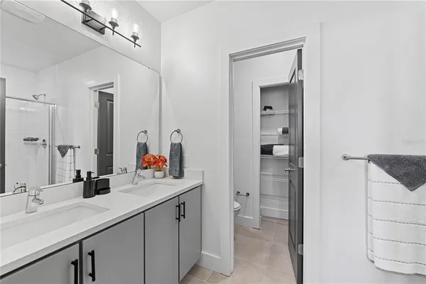 a bathroom with a sink double vanity and a mirror