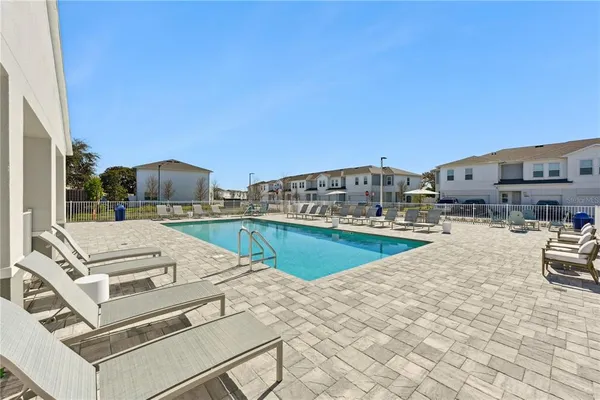 a view of a swimming pool with a lounge chair