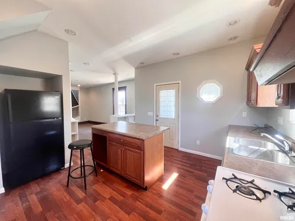 a kitchen with stainless steel appliances granite countertop a stove and a refrigerator