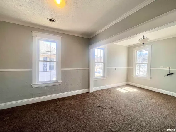 an empty room with windows and closet