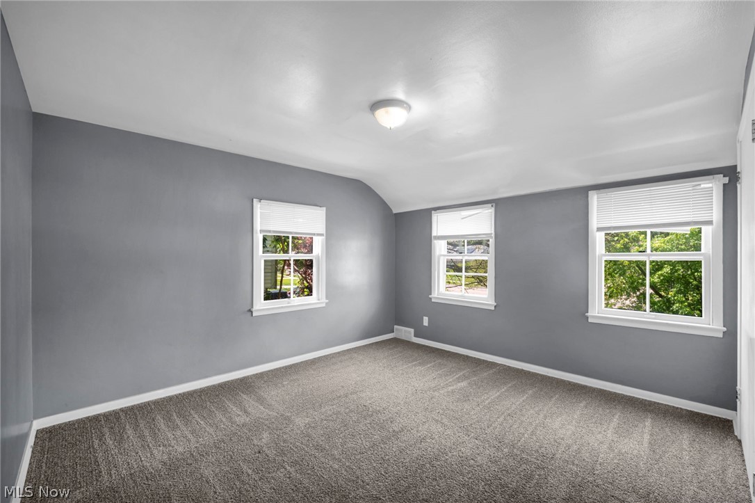 2313 North Taylor Road Cleveland Heights, OH 44112 - Photo 14 of 32 Carpeted room with multiple windows, painted gray walls, white trim, and a flush-mount ceiling light