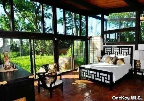 a bedroom with a bed and a view of balcony