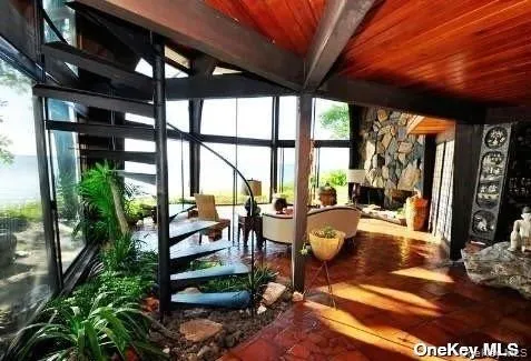 a living room with patio furniture and a floor to ceiling window