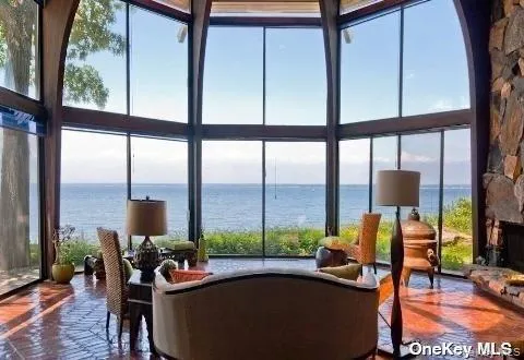 a living room with furniture and a floor to ceiling window