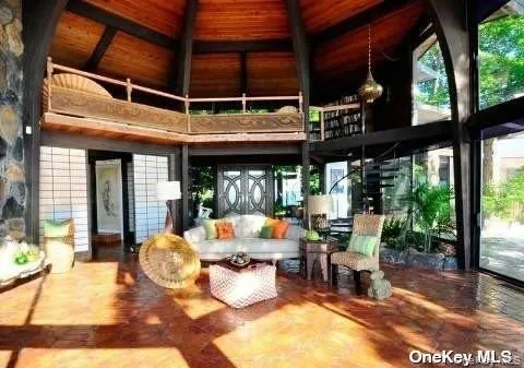 a outdoor space with the couches and dining table with the garden view