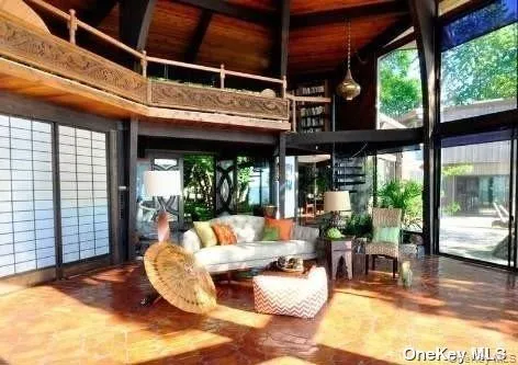 a view of a patio with a dining table chairs and balcony