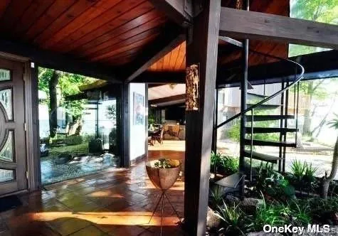a view of a porch with furniture and garden